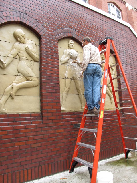 2.1.11 Three Athletes, Christian Petersen, 1936, University Museums, Iowa State University, Ames, IA.  Cleaning terra cotta during conservation treatment.